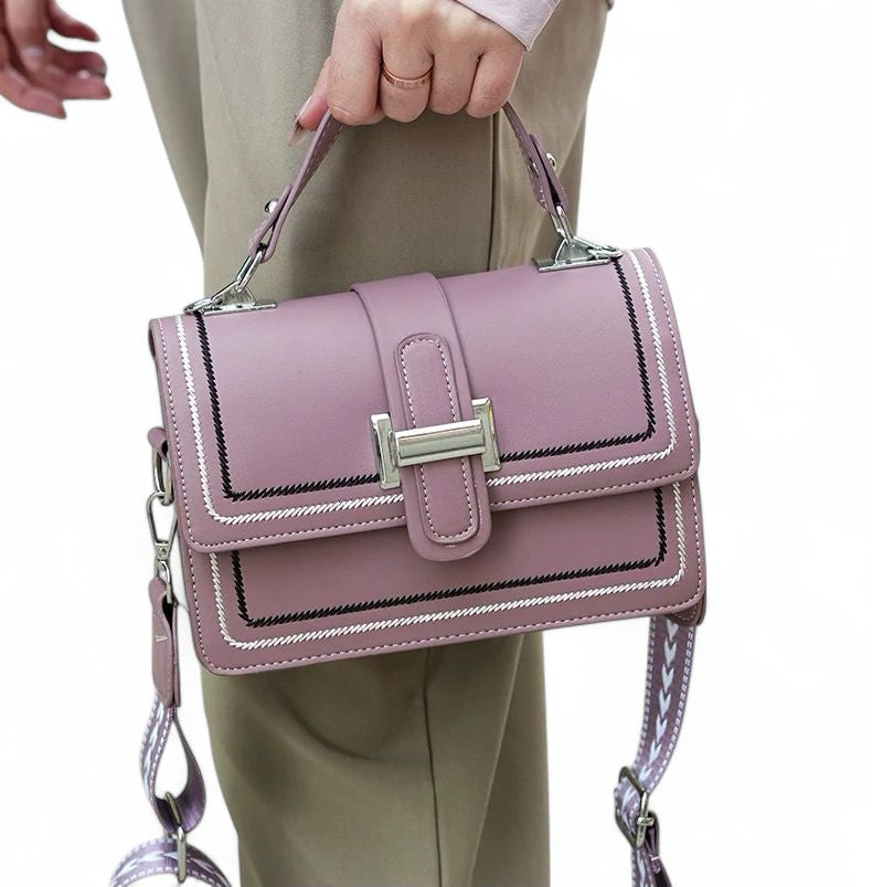 Person holding a pink handbag with a white background