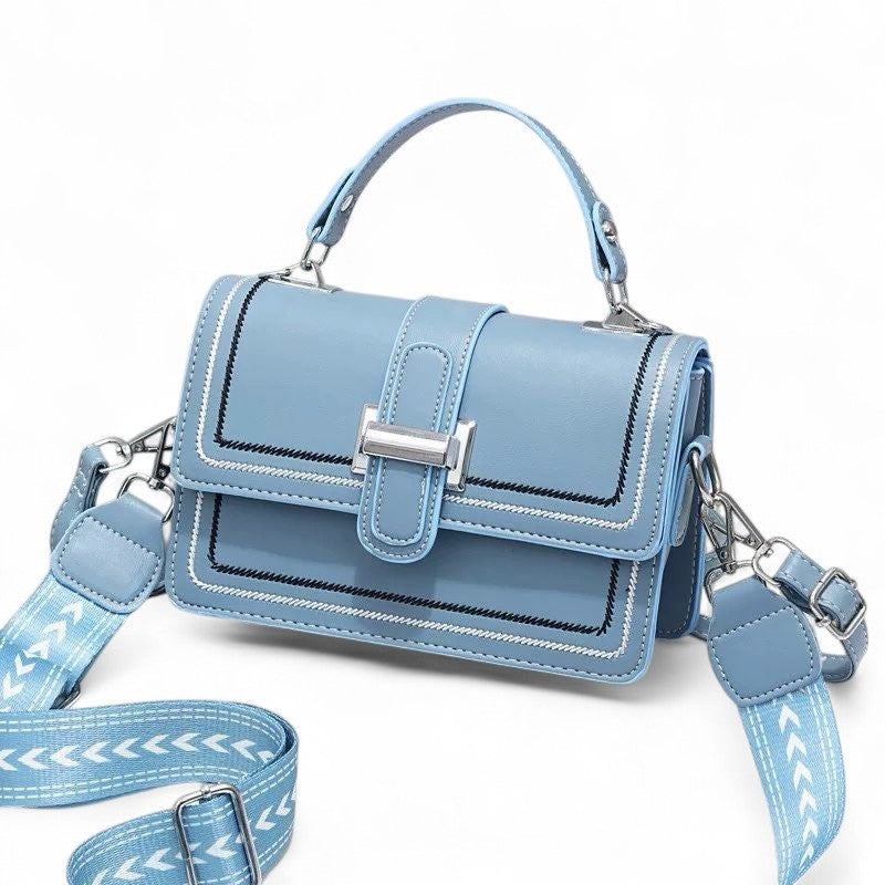 Blue handbag with a matching strap on a white background