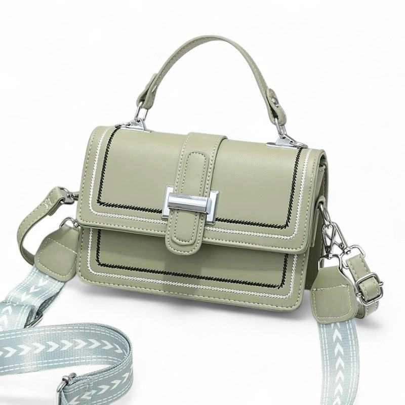 Green handbag with a strap on a white background