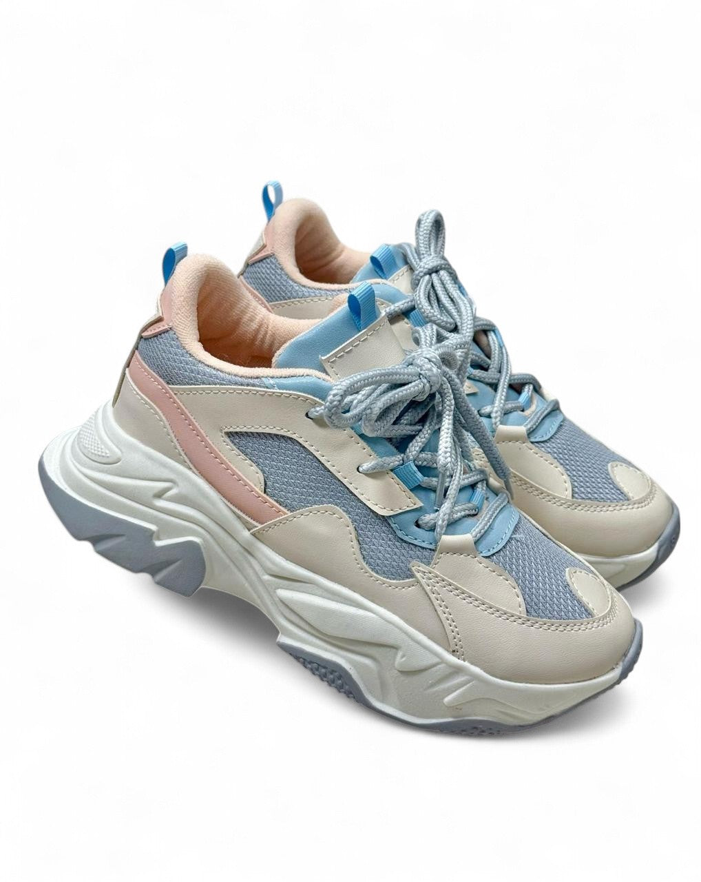 Pair of light blue and beige sneakers on a white background